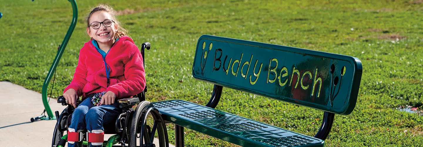 Melody Day smiles while sitting in her wheelchair.