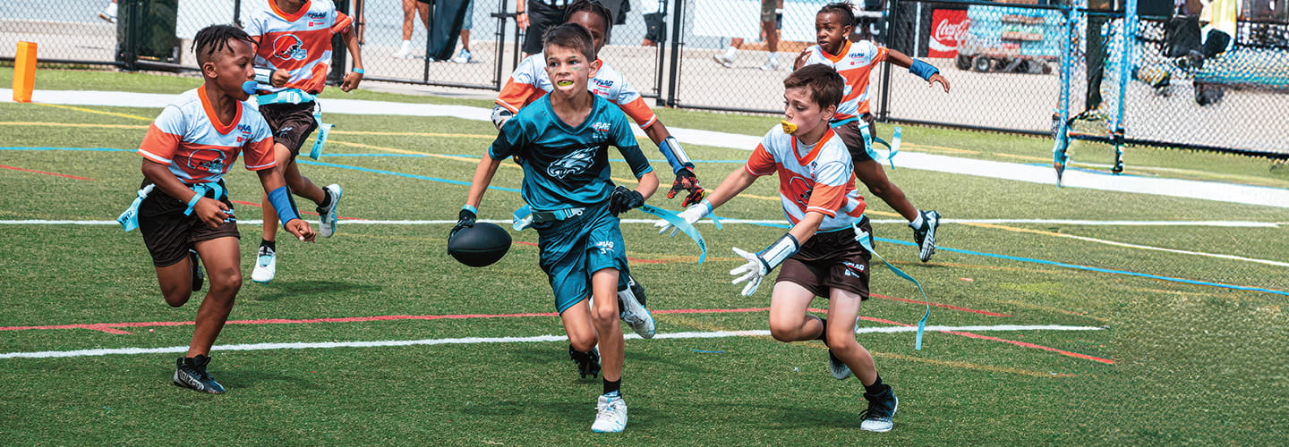 a group of boys playing flag football