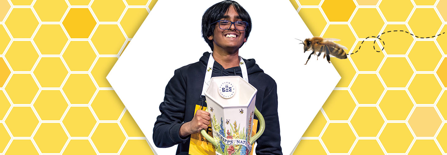 Image of spelling bee champion holding trophy