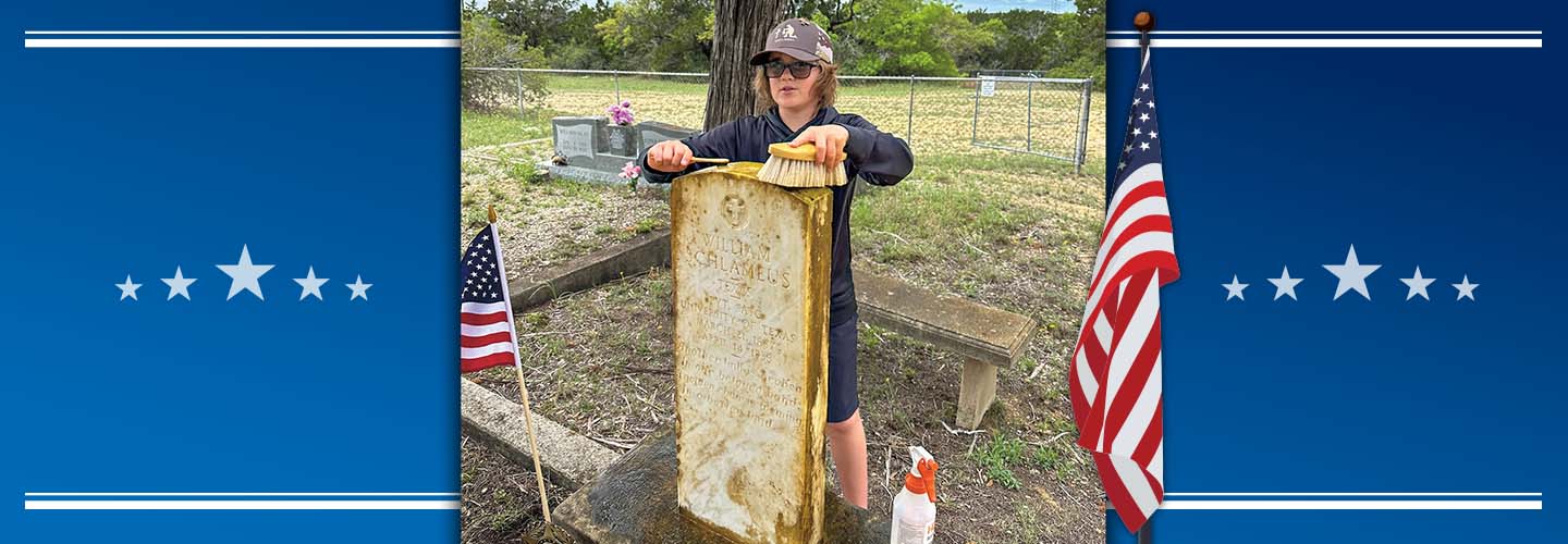 Image of teen cleaning the grave of a veteran
