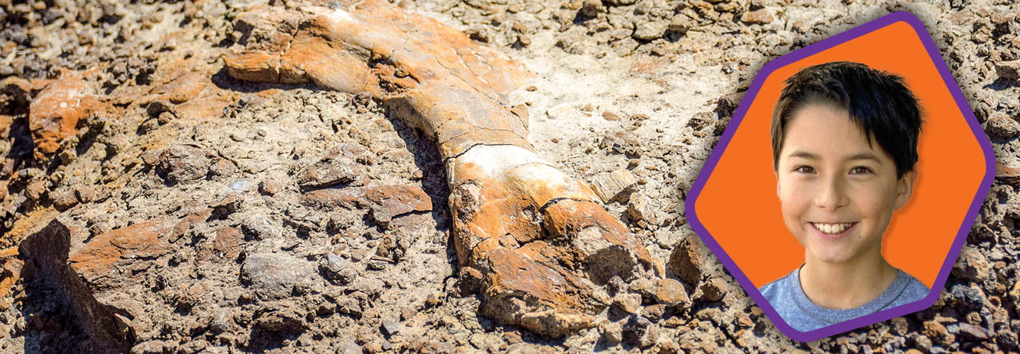 Headshot of a kid and the fossilized bones he found